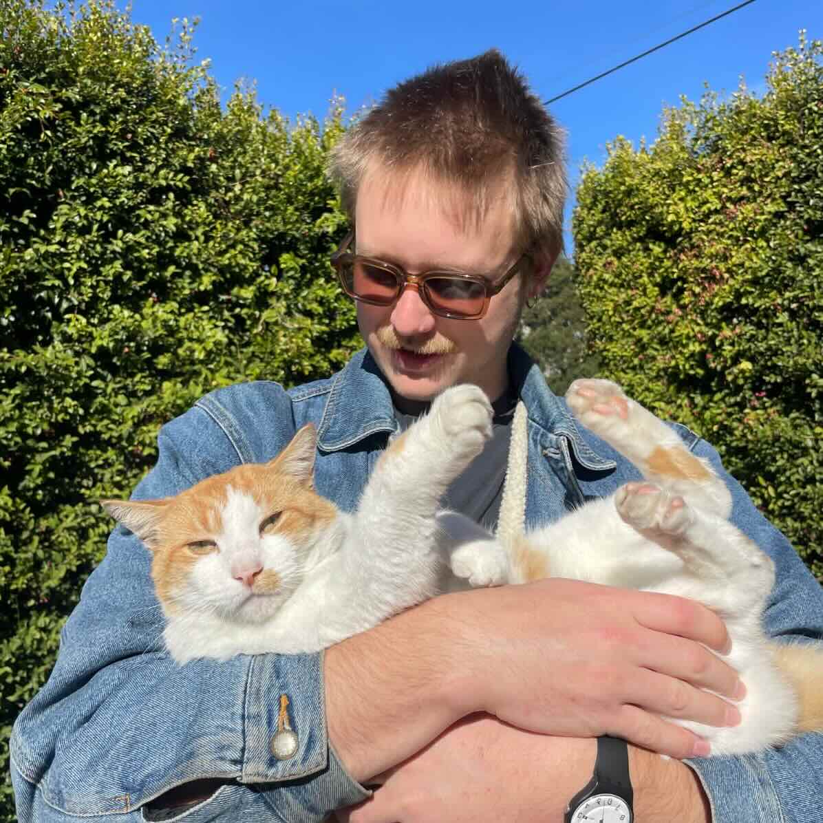 Spencer Drewry working at an electronics bench with test equipment and circuit boards